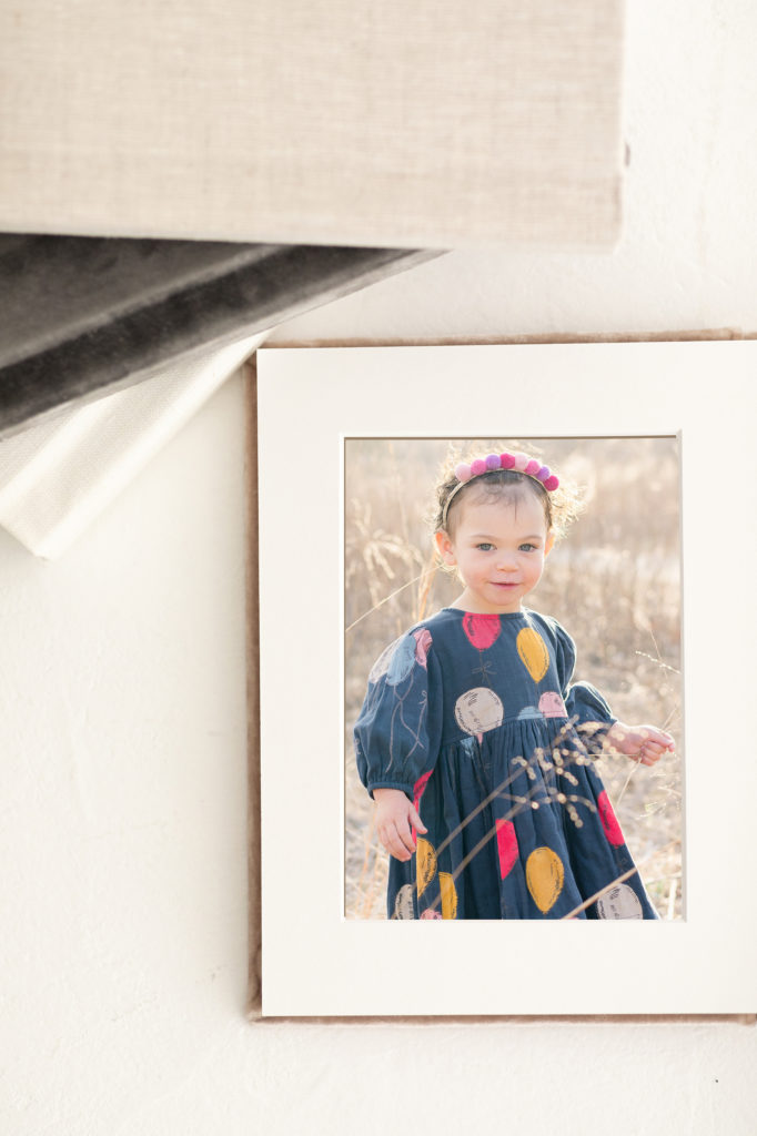 A matted photo album with a velvet cover for family photo preservation.