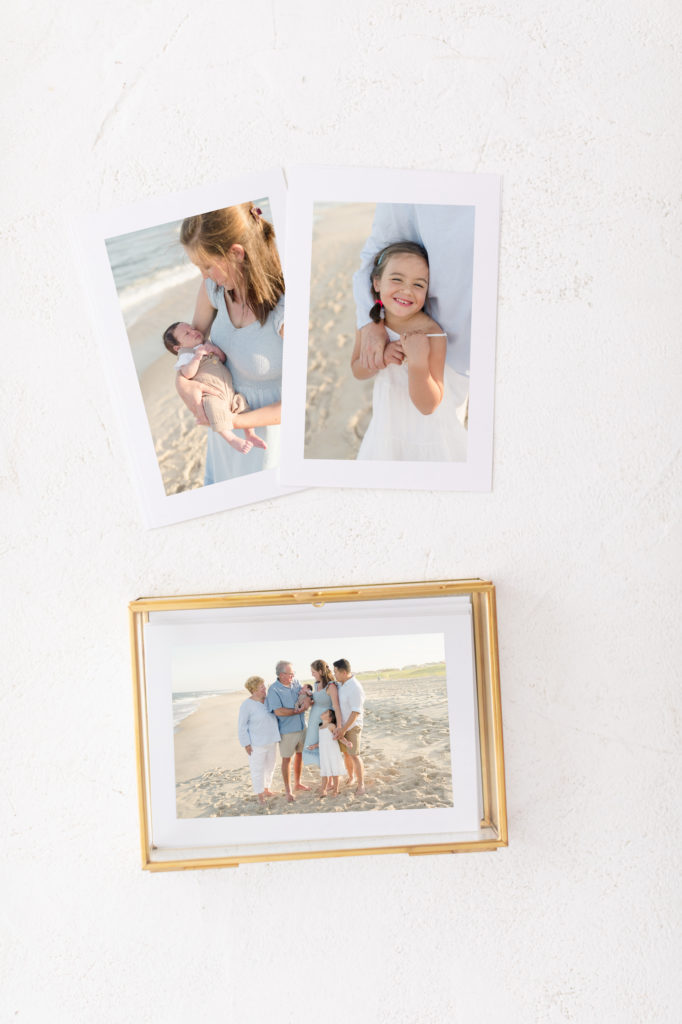 A set of printed photographs of a family beach photoshoot.