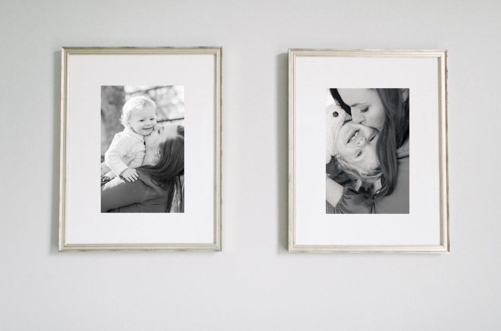 Two black and white fine art framed prints hanging on a wall.