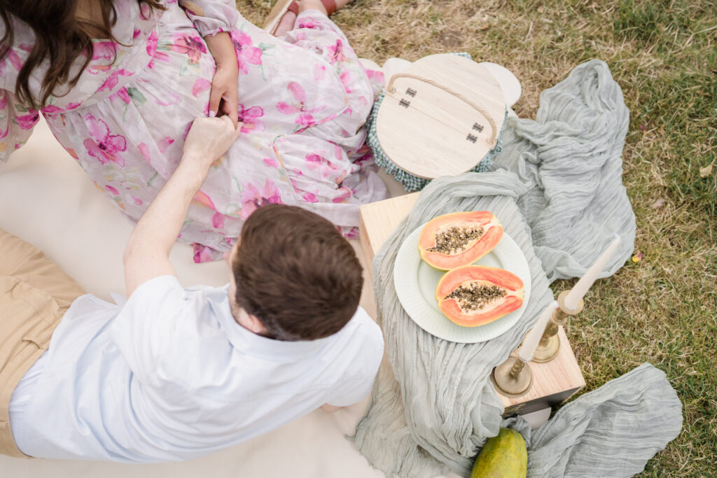 A maternity picnic photoshoot with papayas.