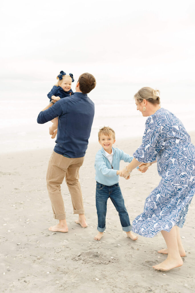 Beach family photos with soft neutral coastal outfits.
