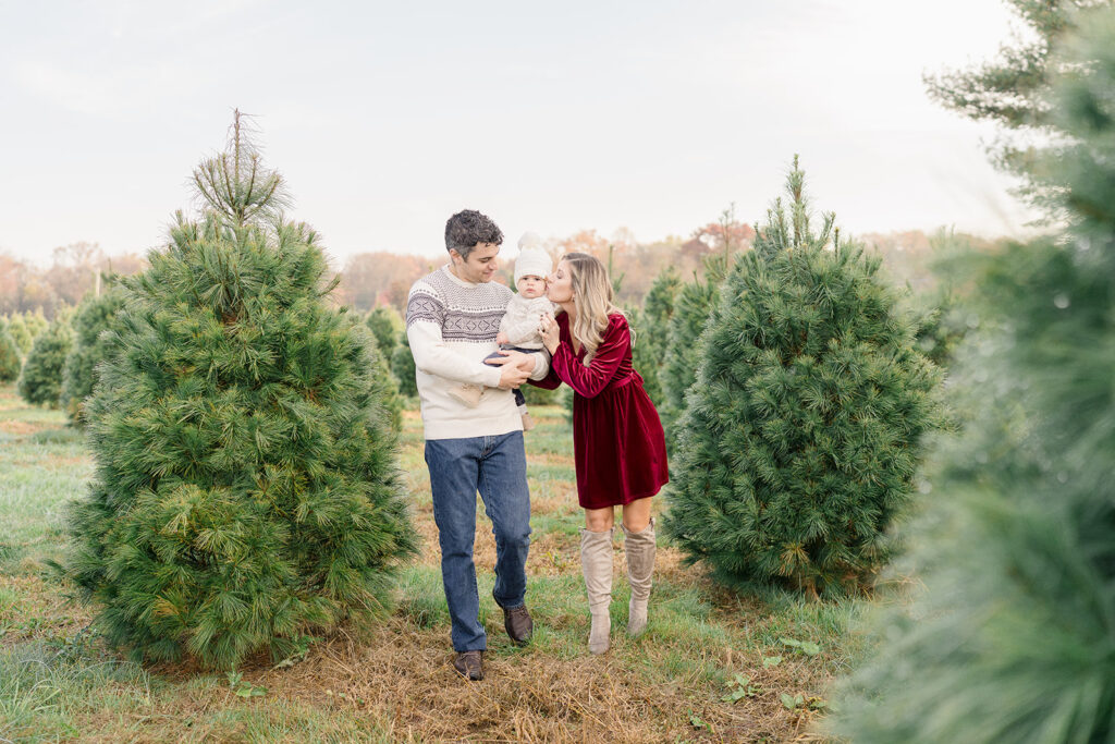 Family walks through the Christmas trees during a holiday mini session in South Jersey.