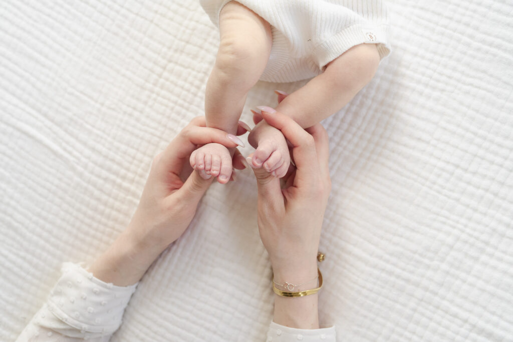 Close up of newborn baby stretching toes during relaxed home session.