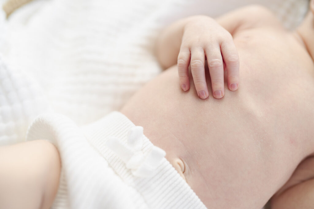 Detail shot of newborn hand near window light.