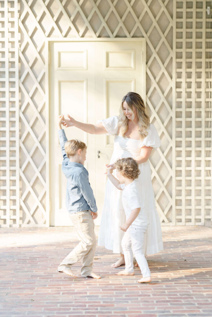 A mom twirls her two boys at Fairmount Park in Philadelphia.