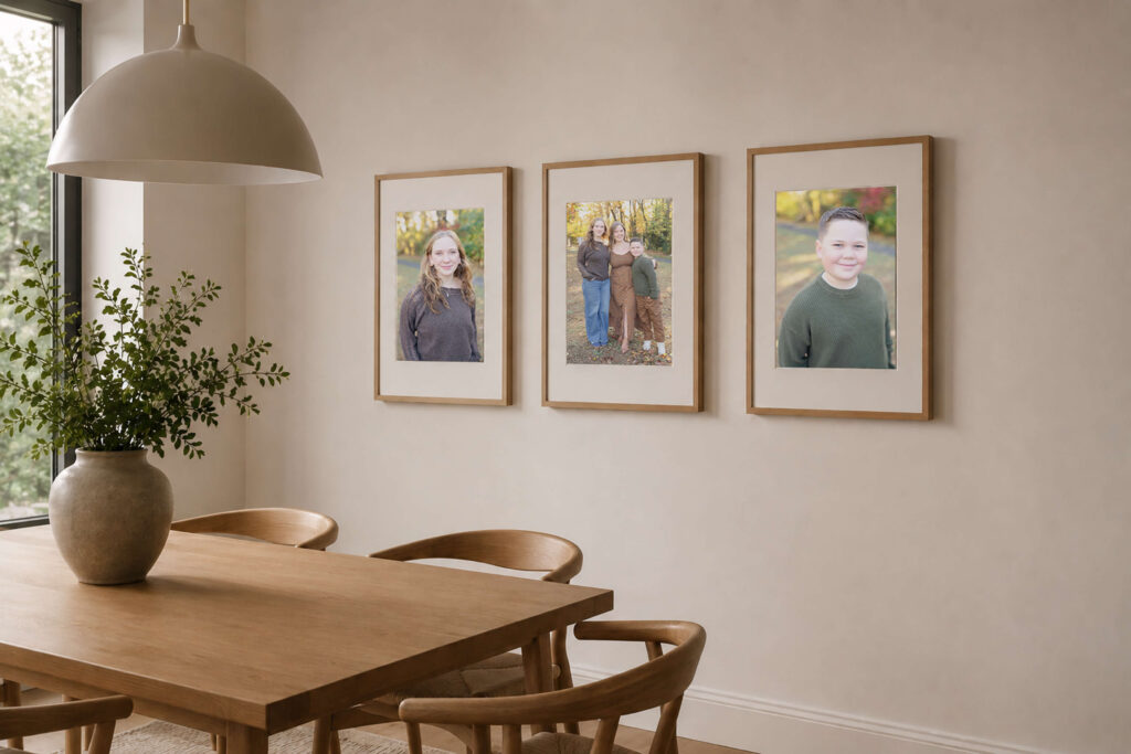 Three 11x14 framed portraits hung on a scandinavian style dining room wall.