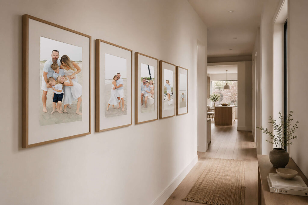 Five large portraits hung in a hallway from a beach photoshoot in Ocean City, NJ.