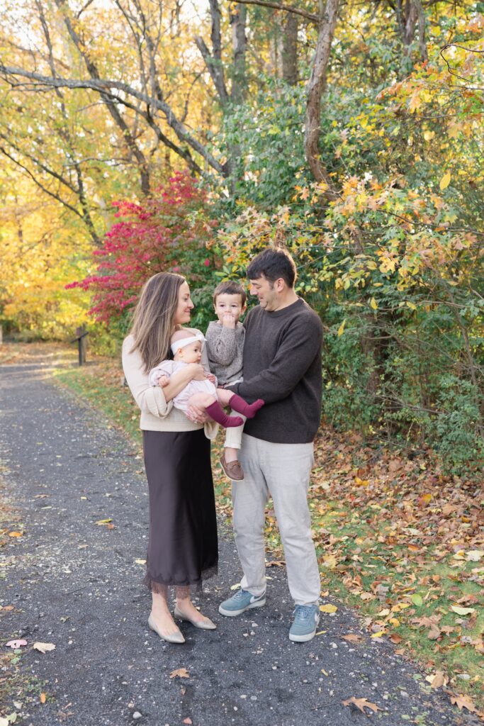 Parents playing with their children during a fall family photography session