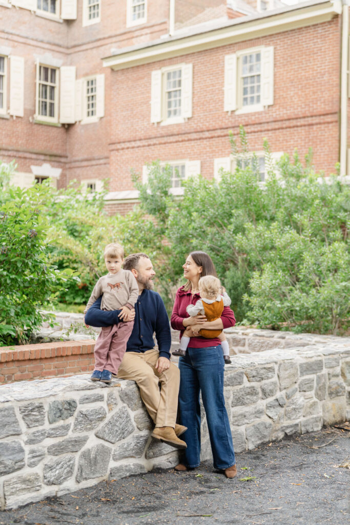 A family of four plays together during their fall photos in Philly.